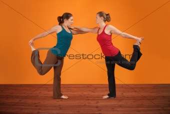 Two Women Perform Yoga