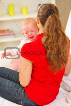 Mother calming crying baby