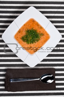 Homemade soup with cabbage on a striped background