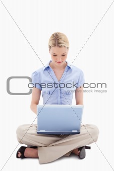 Woman sitting and working on her laptop