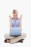 Woman sitting and angry about her laptop