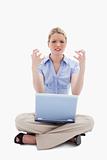 Sitting woman angry about her laptop