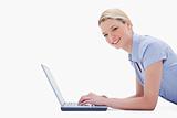 Side view of smiling woman with her laptop