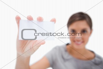 Blank business card being presented by smiling woman