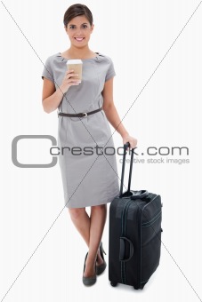 Woman with coffee and wheely bag