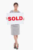Woman holding sold sign