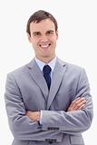 Smiling businessman standing with arms folded