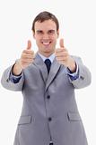 Thumbs up given by smiling businessman