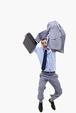 Happy businessman with suitcase jumping
