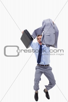 Happy businessman with suitcase jumping