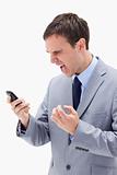 Angry businessman yelling at his cellphone