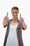 Thumbs up given by smiling woman
