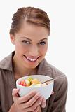 Smiling woman with bowl of fruit salad