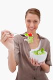 Woman offering salad on a fork