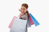 Side view of smiling woman with shopping bags