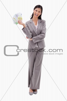 Smiling businesswoman with money