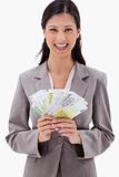 Smiling businesswoman with bank notes in her hands