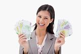 Smiling businesswoman holding money in her hands