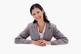 Businesswoman leaning on blank wall