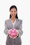 Piggy bank being held by businesswoman