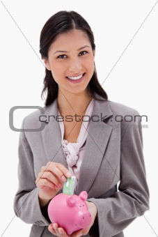 Businesswoman with money and piggy bank