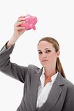 Bank employee holding piggy bank over her head