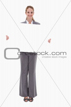Smiling bank employee with blank sign in her hands