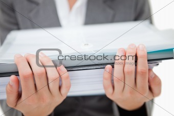 Pile of paperwork being held by female hands