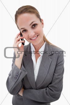 Smiling bank employee on her cellphone