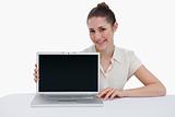 Smiling businesswoman showing a laptop