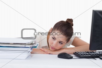 Tired secretary leaning on her desk