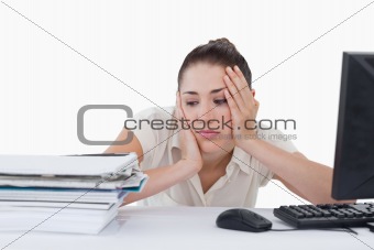 Sad businesswoman leaning on her desk