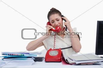 Overburden businesswoman answering the phones