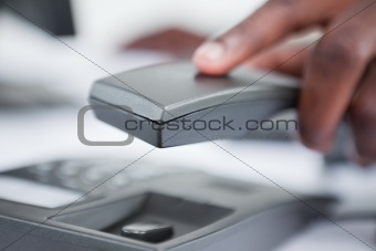 Close up of a masculine hand holding a phone handset