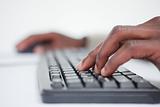 Close up of a masculine hand using a keyboard