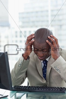 Portrait of a tired office worker using a computer