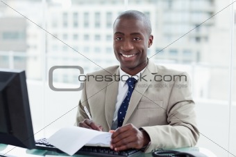 Smiling entrepreneur signing a document