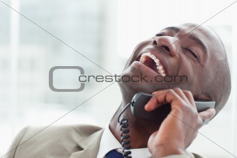 Close up of a delighted businessman on the phone