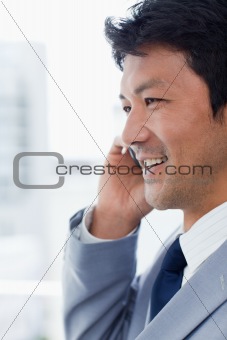 Portrait of a smiling office worker on the phone