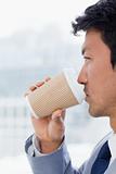Portrait of an office worker drinking a takeaway coffee