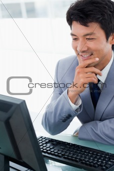 Portrait of a smiling manager using a computer
