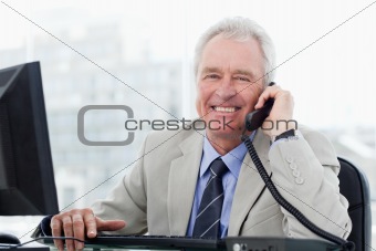 Smiling senior manager on the phone