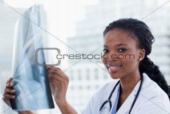 Smiling female doctor looking at a set of X-rays
