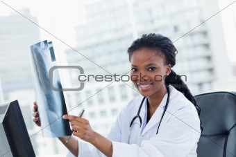 Blissful female doctor looking at a set of X-rays