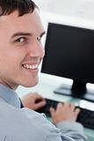 Back view of a smiling businessman using a monitor
