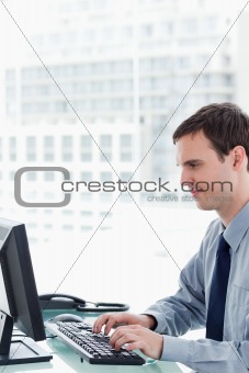 Side view of an office worker using a monitor