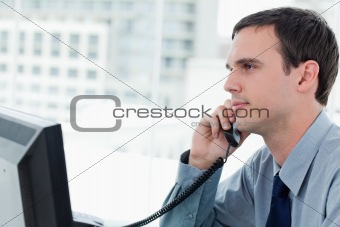 Young office worker on the phone