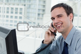 Happy office worker on the phone