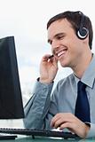 Portrait of a smiling office worker using a headset