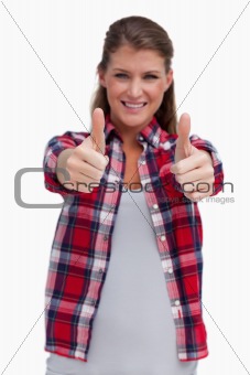 Portrait of a blissful woman with the thumbs up